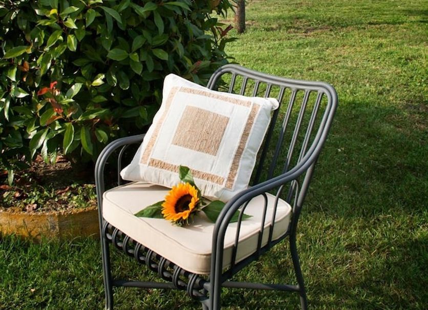 Alla Corte Del Picchio Room & Breakfast in Castel Guelfo di Bologna with a chair in a grassy garden