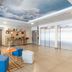 Appart'City Confort Perpignan Centre Gare lobby with seating, elevator, and decorative ceiling mural