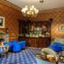 Tre-Ysgawen Hall & Spa in Llangefni: elegant lounge bar with blue armchairs, chandelier, and patterned carpet