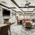 Homewood Suites by Hilton Henderson South Las Vegas lounge with fireplace, tables, chairs and ceiling fans