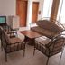 Eden Beach Saint-Louis lounge with sofa seating, wooden table, TV, and bright balcony doors
