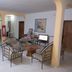 Eden Beach Saint-Louis lounge with metal seating area, TV, table, and refrigerator in Saint-Louis