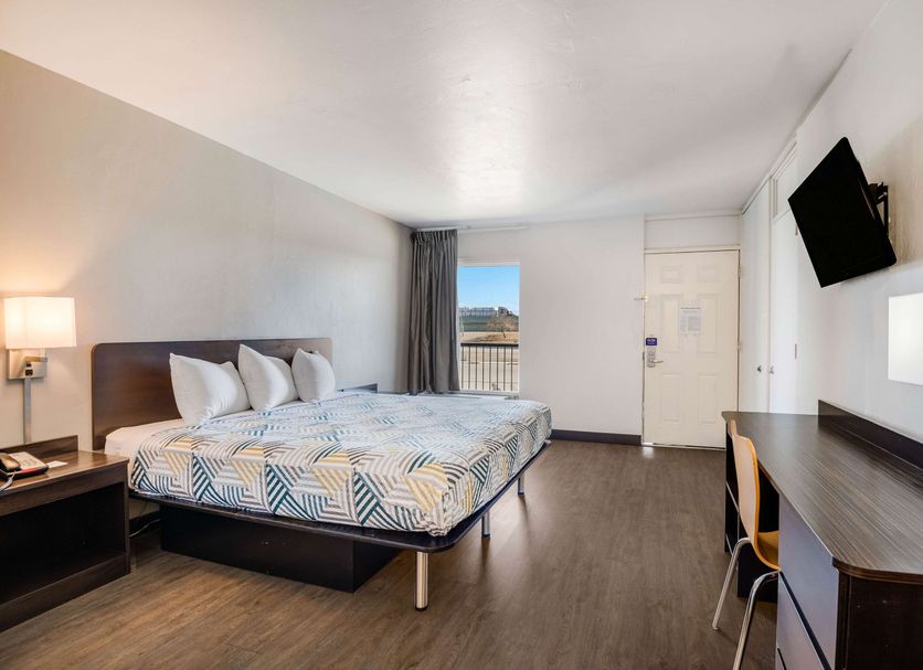 Motel 6 Tucson, AZ - Downtown guest room with king bed, desk, wall-mounted TV, and city view