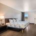 Motel 6 Tucson, AZ - Downtown guest room with king bed, desk, wall-mounted TV, and city view