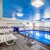 Motel 6 Indianapolis - Southport indoor pool with lounge chairs and blue ceiling in Indianapolis