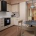Sky Hotel Apartments Stockholm kitchenette and dining area with table, chairs, and hallway view