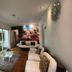 Casa Hotel Boyaca Real Bogotá lounge with sofa, coffee table, wall art and garden-view glass doors