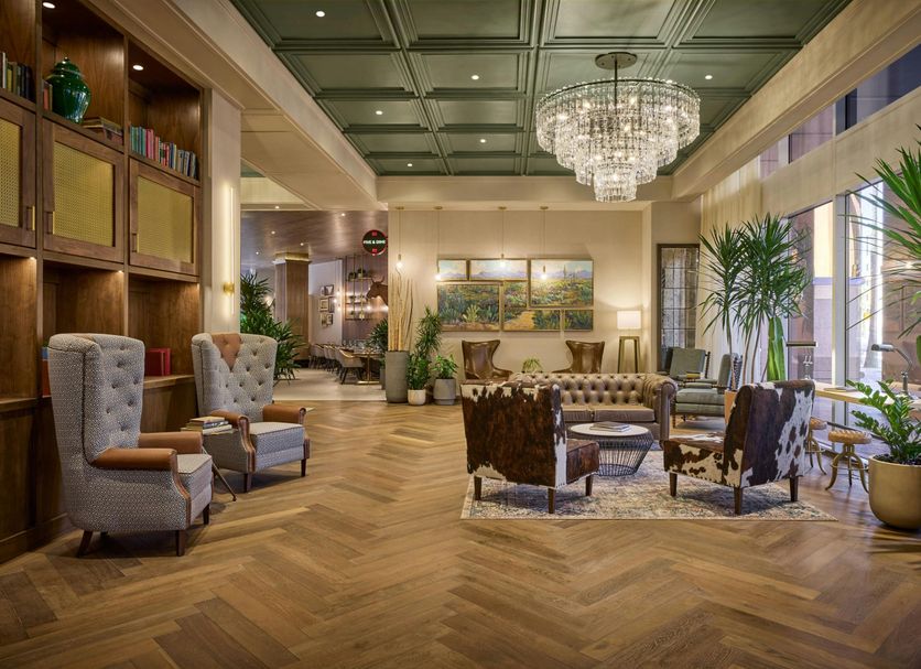 The Leo Kent Hotel, Tucson lobby with crystal chandelier, tufted chairs and tall windows