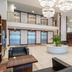 Exe Convention Plaza Madrid lobby in Madrid with modern seating, pendant lights, and indoor planter