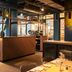 Conscious Hotel The Tire Station, Amsterdam bar and restaurant interior with counter seating and large windows