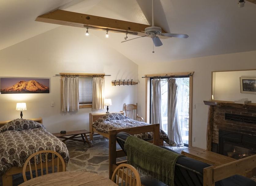 Whittaker's Motel & Historic Bunkhouse room in Ashford with two beds, fireplace, vaulted ceiling and balcony door