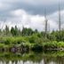 Lake Placid Inn: Residences in Lake Placid with a calm lake and lush shoreline under cloudy skies