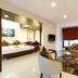 Yogi Executive, Navi Mumbai suite with bed, sofa, glass table and window seating area