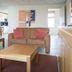Studio's De Vlijt Texel living area with sofas, coffee table and kitchen view in De Cocksdorp