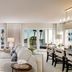 Balboa Bay Resort in Newport Beach living room with bay views, sofa seating, dining table and balcony doors