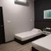 Luna Capsule in Semporna guest room with two single beds, wall art, and air conditioner