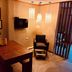 Boutique Hotel Casa Teatro in Manaus, lounge with wooden table, black chair, wall TV and pendant lights