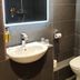 The Bingham Townhouse Nottingham bathroom with sink, toilet, mirror, and tiled shower area