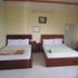Hanh Long 2 Hotel in Ho Chi Minh City room with two twin beds, desk, mirror and wall AC