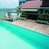 Jaguary Hotel Sumaré rooftop pool with city views, wooden deck and outdoor seating