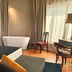 Triviho Hotel in Rome room with freestanding tub, large bed, and desk by the window