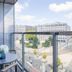 Downtown Apartments Mitte, Berlin balcony with table and chairs overlooking city street and buildings