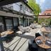 Hotel Am Schloss Ahrensburg patio with outdoor dining tables and seating in Ahrensburg
