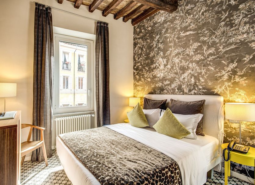 Trevi Beau Boutique Hotel Rome guest room with double bed, window view and patterned wallpaper