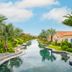 Centara Mirage Resort Mui Ne in Phan Thiet with a tropical canal and palm-lined villas