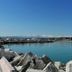 Ristorante Hotel Lucia in Giulianova with harbor view and rocky shoreline beside calm blue water