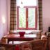 Pension an der Pillnitzer Schlossfähre Dresden room with table, wicker chairs, kitchenette and window seat