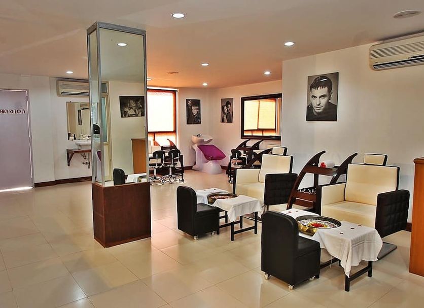 Pride Sun Village Resort & Spa in Arpora lounge with chairs, tables, wall art and air conditioning