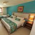 Sobrado da Vila Hotel in Mata de São João guest room with double bed, teal accent wall and window seating