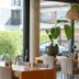 Gästehaus am Schloss in Schwetzingen breakfast room with large windows overlooking a garden courtyard