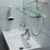 Hotel Vinothek Schwarzer Adler in Ottensheim bathroom sink with wall-mounted hair dryer and glass shelf