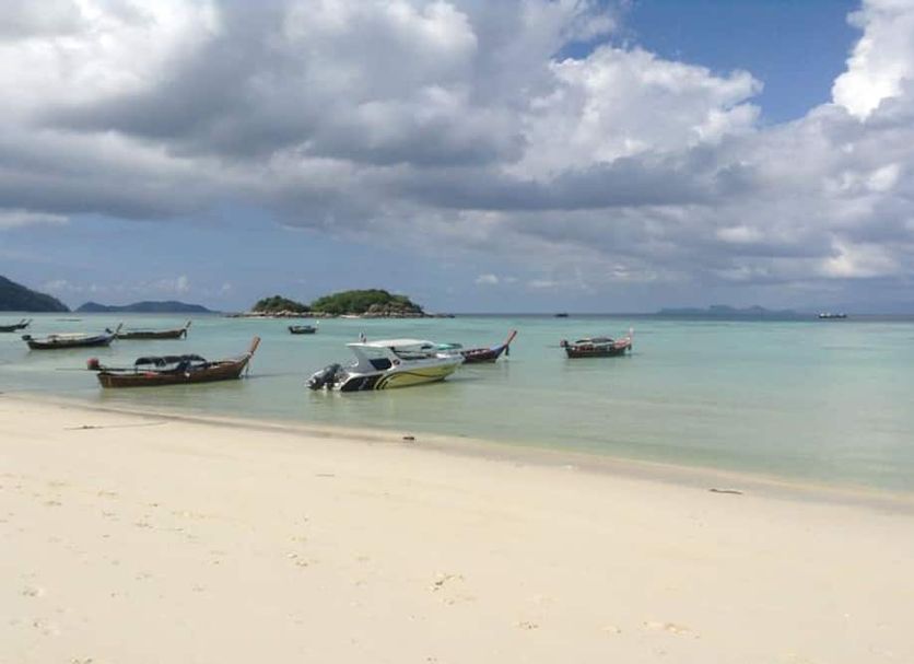 Adang Sea Divers & Eco Lodge in Ko Lipe: beachfront with longtail boats and calm turquoise sea