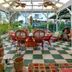 Hale Kawehi Bnb Guesthouse in Hilo: covered patio with wicker dining set, plants, and checkered floor