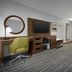 Hampton Inn Yorkville guest room with king bed, desk, TV, and work chair