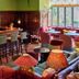 Penmaenuchaf Hotel bar lounge in Dolgellau with wooden counter, stools, and colorful seating