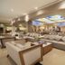 Hotel Marina El Cid Spa lobby lounge in Puerto Morelos with sofas and stained-glass skylight