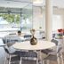 B&B Hotel Figueres dining area with round tables and chairs in a bright modern room
