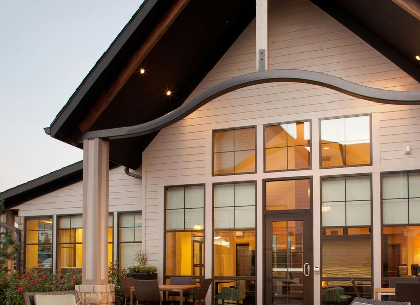 Residence Inn by Marriott Lincoln South exterior with fire pit and outdoor lounge seating at dusk
