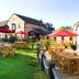 Outdoor seating area at Premier Inn Northampton South - Wootton in Northampton with picnic tables and umbrellas