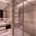 Braira Al Nakheel in Riyadh bathroom with glass shower enclosure and modern vanity sink