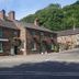 The Family Tree in Matlock, stone hotel building beside a road with hanging flower baskets