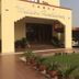 Hotel Maiden Residency in Ghāziābād with a landscaped entrance, potted plants, and covered driveway