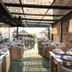Olivia Plaza Hotel Barcelona restaurant with glass سقiling, terrace seating and outdoor dining area