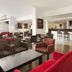 Ramada by Wyndham Wakefield lobby lounge in Ossett with bar seating and red armchairs