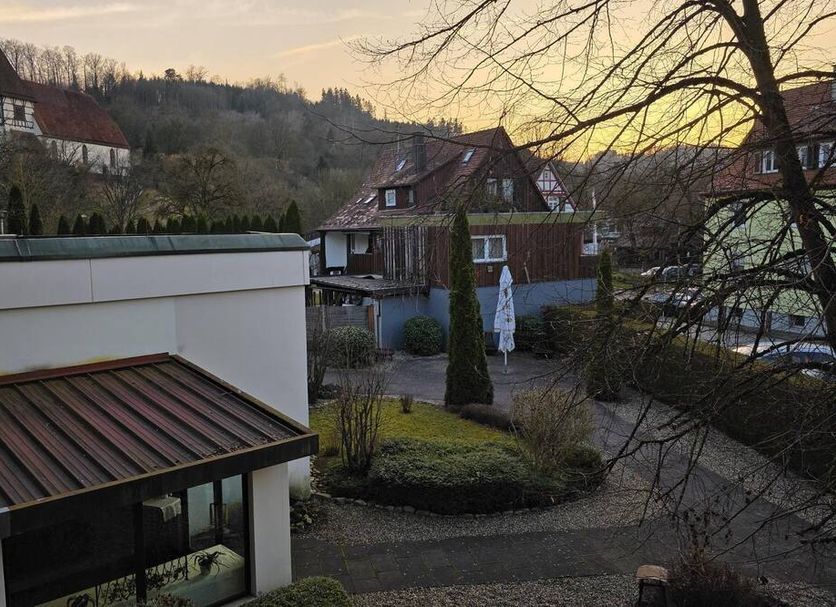Hotel Sonne Post in Murrhardt with courtyard view at sunset and surrounding hillside homes