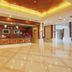 Fuhong International Hotel in Liaoyang lobby with glossy tile floors, front desk and warm ceiling lighting